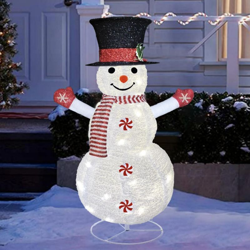 Photo 1 of Mosy Lighted Christmas Snowman Decorations, 4FT Outdoor Collapsible White Snowman with Built-in LED Lights, Pre-Lit Pop Up Xmas Snowman, Light Up for Holiday New Year Winter Decor