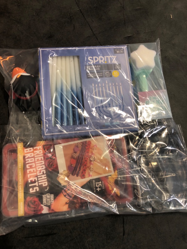 Photo 1 of 6 Mixed Items- 1 Belt Buckle, 1 Pack of Bath Crayons, 1 Penguin Rubber Duck, 1 Facial Brush, 1 DIY Friendship Bracelet, 1 Pack of Menorah Candles