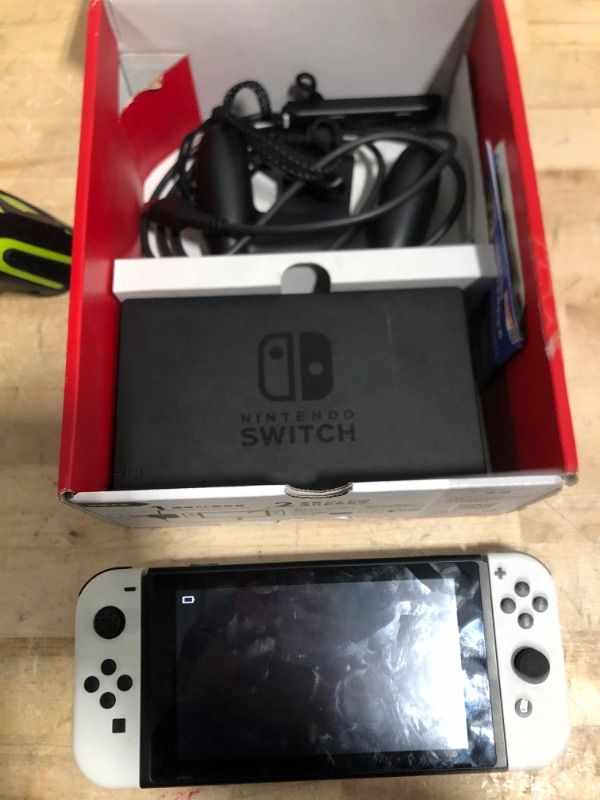 Photo 4 of This is Hong Kong or Japanese version, some scratcheS
Nintendo Switch OLED Model w/ White Joy-Con ***Missing thumbstick cover on left stick, missing power adapter/Unable to test/power cycles due to low battery. Looks like swap with regular switch model wi