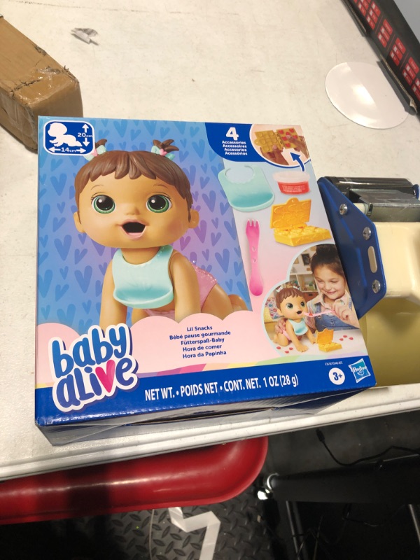 Photo 2 of ***USED***BABY ONLY***Baby Alive Lil Snacks Doll, Eats and Poops, Snack-Themed 8-Inch Baby Doll, Toy for Kids Ages 3 and Up, Brown Hair