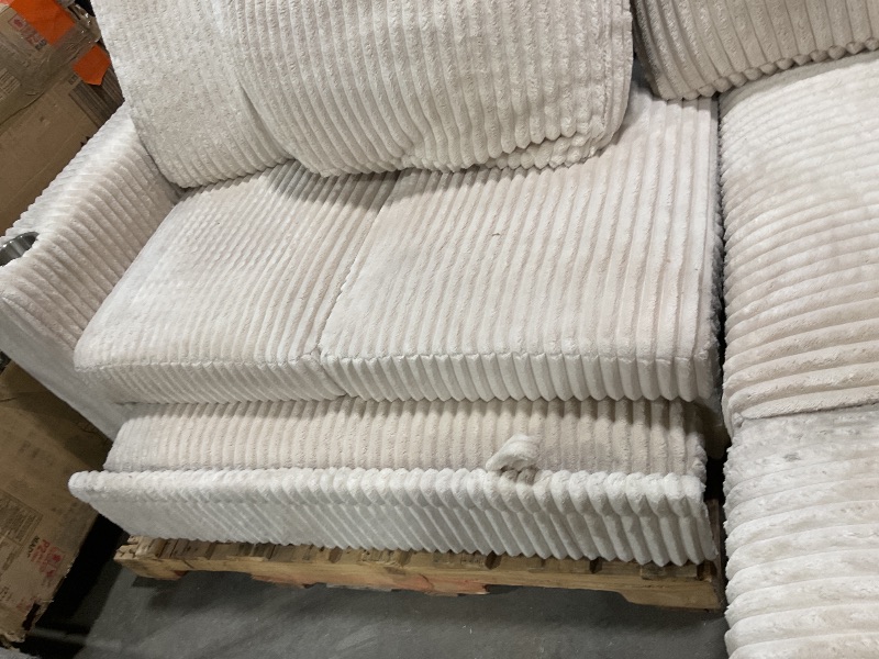 Photo 1 of **TEARS. MISSING LEGS ON MIDDLE SECTION** DIRT FROM TRANSPORT **White couch corner set.