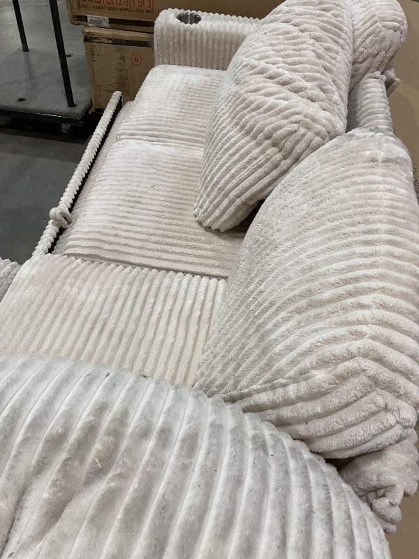 Photo 1 of **TEARS. MISSING LEGS ON MIDDLE SECTION** DIRT FROM TRANSPORT **White couch corner set.