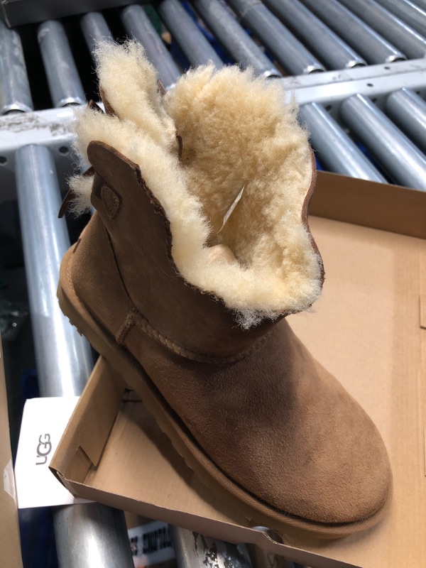 Photo 4 of **1 BOOT IS DAMAGED, MISSING A CHUNK, SEE PHOTO**
UGG Women's Mini Bailey Bow Ii Boot, Chestnut, - SIZE 7 WOMENS