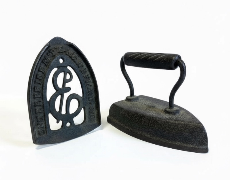 Photo 1 of ANTIQUE SAD IRON AND MATCHING TRIVET