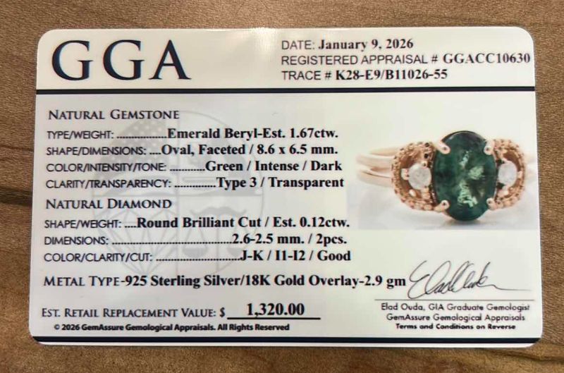 Photo 1 of STERLING SILVER W 18K GOLD OVERLAY W NATURAL EMERALD BERYL APPROX 1.67 CTW OVAL FACETED AND NATURAL DIAMOND 0.12 CTW RING GGA CERTIFIED (EST SIZE 7) -RN040644