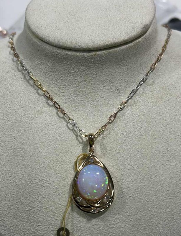 Photo 1 of STERLING SILVER W 18K GOLD OVERLAY W NATURAL OPAL (PLAY OF COLOR) APPROX 11.08 CTW OVAL CABOCHON PENDANT AND NATURAL DIAMOND 0.20 CTW GGA CERTIFIED -NK017293