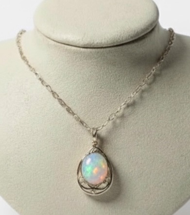 Photo 1 of STERLING SILVER W 18K GOLD OVERLAY W NATURAL OPAL (PLAY OF COLOR) APPROX 11.08 CTW OVAL CABOCHON PENDANT AND NATURAL DIAMOND 0.20 CTW GGA CERTIFIED -NK017293