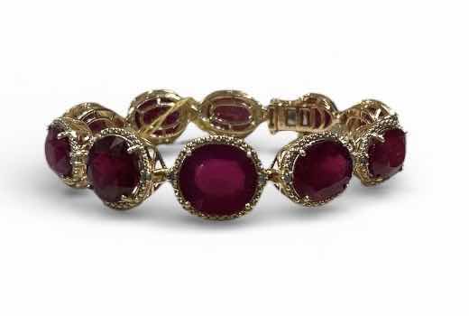 Photo 1 of STERLING SILVER W GOLD OVERLAY W NATURAL RUBY CORUNDUM OVAL BRILLIANT FACETED (10 PCS) APPROX 85.98 CTW AND NATURAL DIAMOND ROUND BRILLIANT CUT 0.65 CTW BRACELET GGA CERTIFIED -BR009104