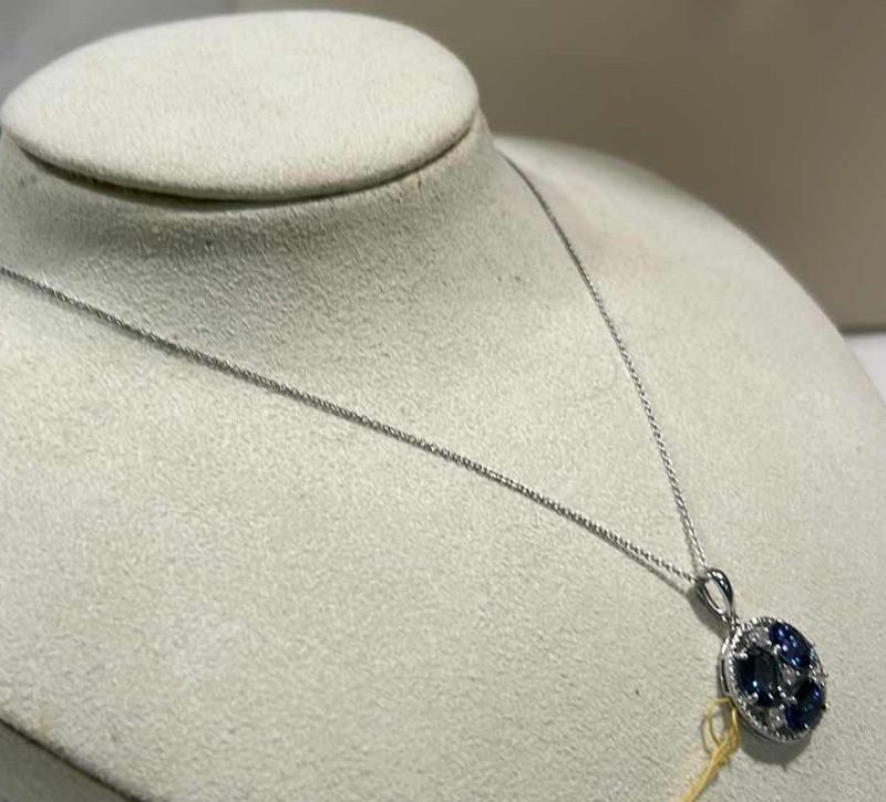 Photo 1 of STERLING SILVER W NATURAL TANZANITE ZOISITE (3 PCS) APPROX 3.82 CTW OVAL FACETED PENDANT AND NATURAL DIAMOND 0.28 CTW GGA CERTIFIED -NK017297