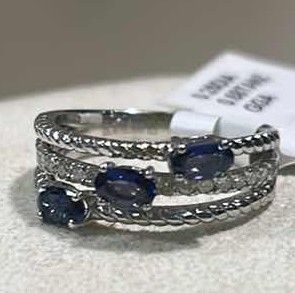 Photo 1 of 925 STERLING SILVER TANZANITE & DIAMOND RING
3 TANZANITES APPROX 0.68 CTW AND DIAMONDS APPROX 0.25 CTW
GGA CERTIFIED (EST SIZE 7)- RN040645