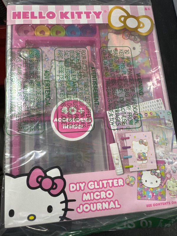 Photo 2 of Hello Kitty DIY Glitter Micro Journal by Horizon Group USA, 40+ Stationery Accessories Including Hello Kitty Stickers, Surprise Keychain, Interchangeable Binder Discs, Squishy Glitter Cover & More