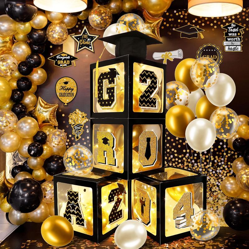 Photo 1 of Meonum Graduation Decorations Class of 2023, 4 Pcs Graduation Balloon Boxes with LED Light Strings, Congrats Grad Cap, Grad 2023 Letters and 40 Pcs Latex Balloons for Grad Party Decor (Gold, Black)