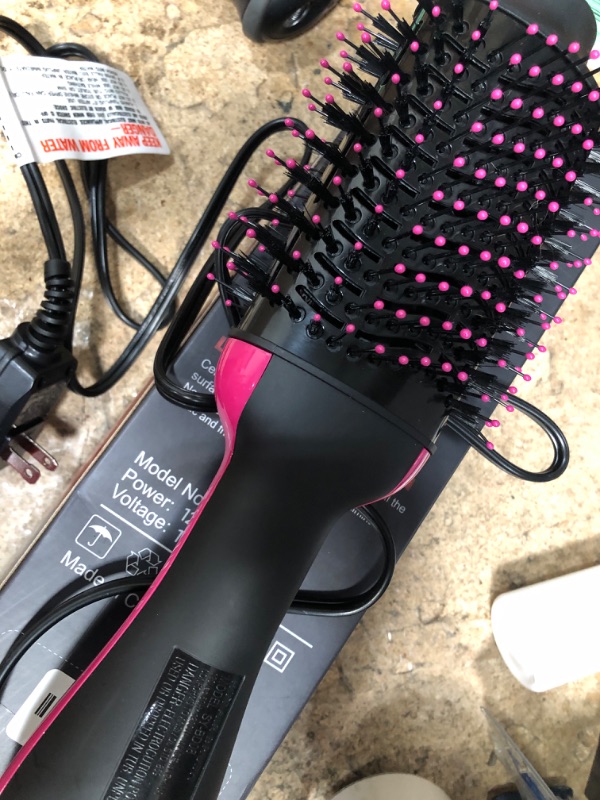 Photo 2 of **POWERS ON**
Hair Dryer and Blow Dryer Brush in One, 4 in 1 Hair Dryer and Styler Volumizer with Negative Ion Anti-frizz Ceramic Titanium Barrel Hot Air Straightener Brush 75MM Oval Shape, Black/Pink