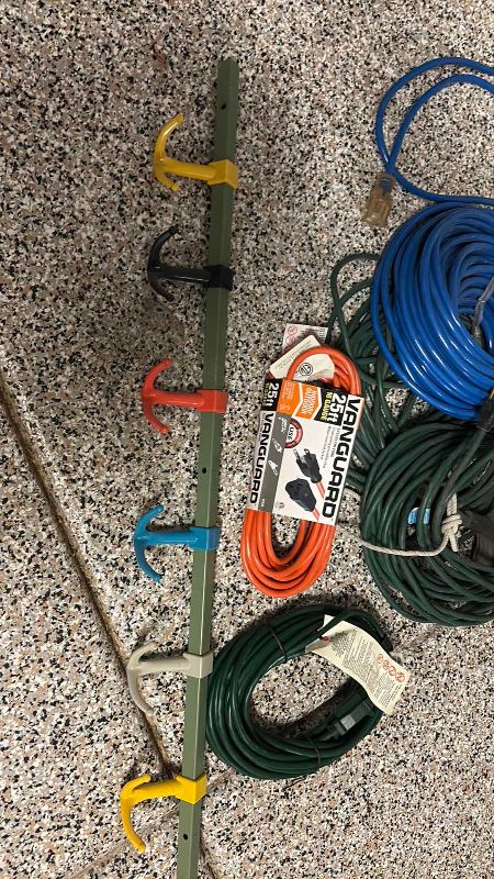Photo 1 of ASSORTED SIZE ELECTRICAL EXTENSION CORDS AND RACK