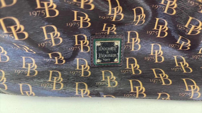 Photo 1 of DOONEY AND BURKE DESIGNER BUCKET ADJUSTABLE STRAPS AND DRAWSTRING CLOSING  WITH KEY CHAIN AND DUST COVER