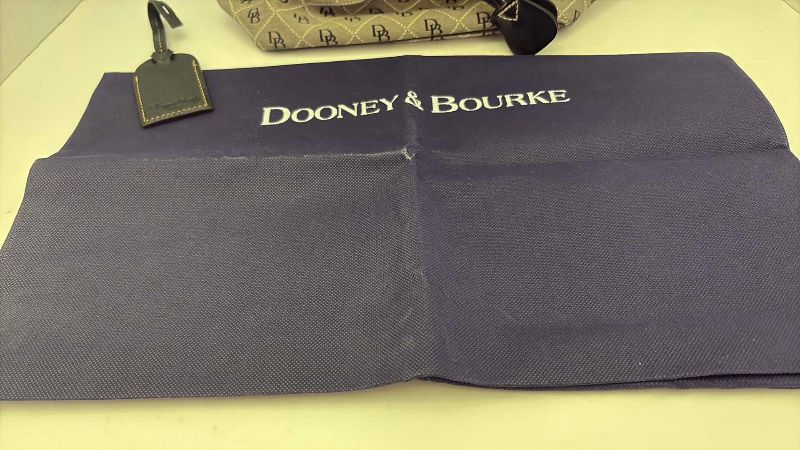 Photo 1 of VINTAGE DOONEY AND BOURKE BUCKET BAG WITH DUST COVER