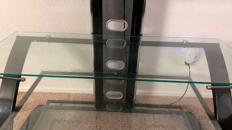 Photo 1 of VIZIO VO420E TELEVISION AND GLASS AND METAL ROTATING TELEVISION STAND 44” X 21” H 61”