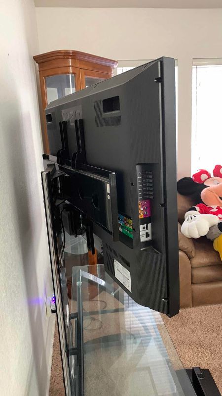 Photo 1 of VIZIO VO420E TELEVISION AND GLASS AND METAL ROTATING TELEVISION STAND 44” X 21” H 61”