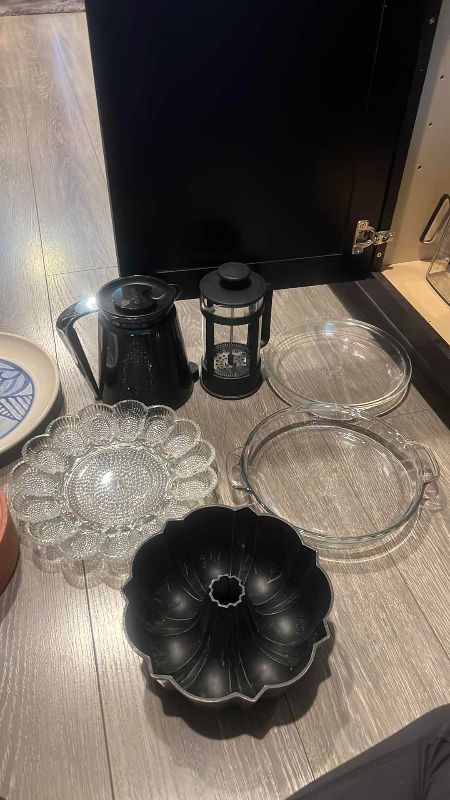 Photo 1 of CONTENTS OF CABINET NICE PLATES, TORTILLA HOLDER, CAKE PANS, COFFEE PRESS, ELECTRIC WATER HEATER