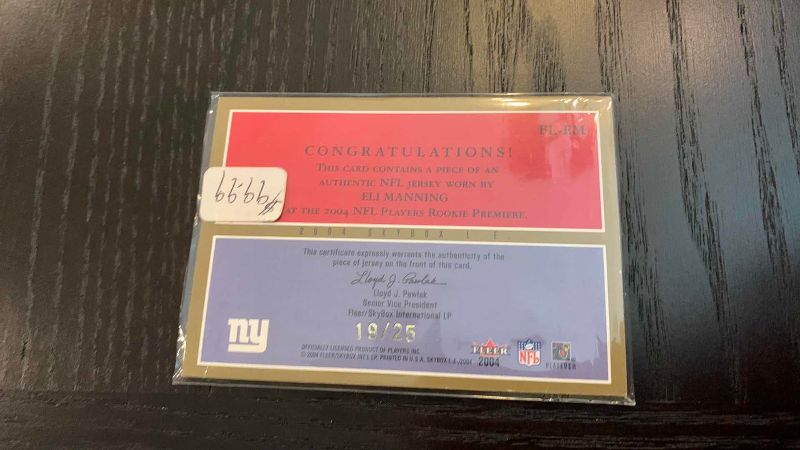 Photo 1 of 2004 FLEER ELI MANNING JERSEY CARD 19/25 NFL FOOTBALL
