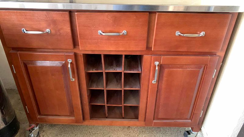 Photo 1 of PORTABLE KITCHEN ISLAND CART W WOOD FINISH, STAINLESS STEEL TOP, BUILT-IN WINE RACK 44” X 21” H 35”