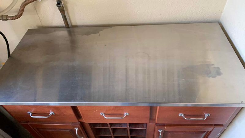 Photo 1 of PORTABLE KITCHEN ISLAND CART W WOOD FINISH, STAINLESS STEEL TOP, BUILT-IN WINE RACK 44” X 21” H 35”