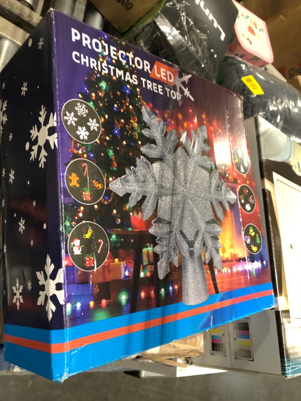 Photo 1 of DG-Direct Christmas Tree Topper Lighted with 6 Projected Patterns, Led Rotating Magic Snowflake, 3D Hollow Glitter Lighted Silver Snow Tree Topper for Christmas Tree Decorations, Silver
