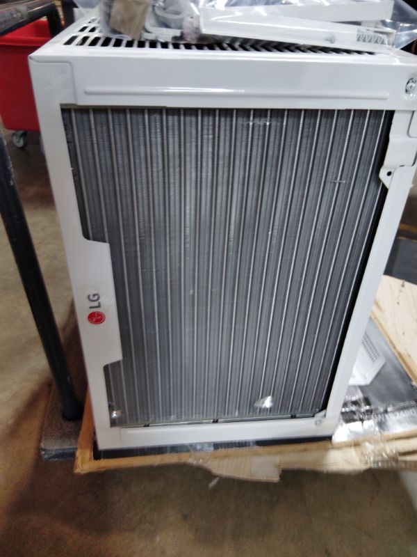 Photo 1 of ***FOR PARTS ONLY/ HAS MINOR OUTER DAMAGE/ COMPRESSOR STARTS & STOPS **** LG 18,000 BTU Window Air Conditioner, 230/208V, Cools 1,000 Sq.Ft. (25' x 40' Room Size), Quiet Operation, Electronic Control with Remote, 3 Cooling & Fan Speeds, Auto Restart, Whi