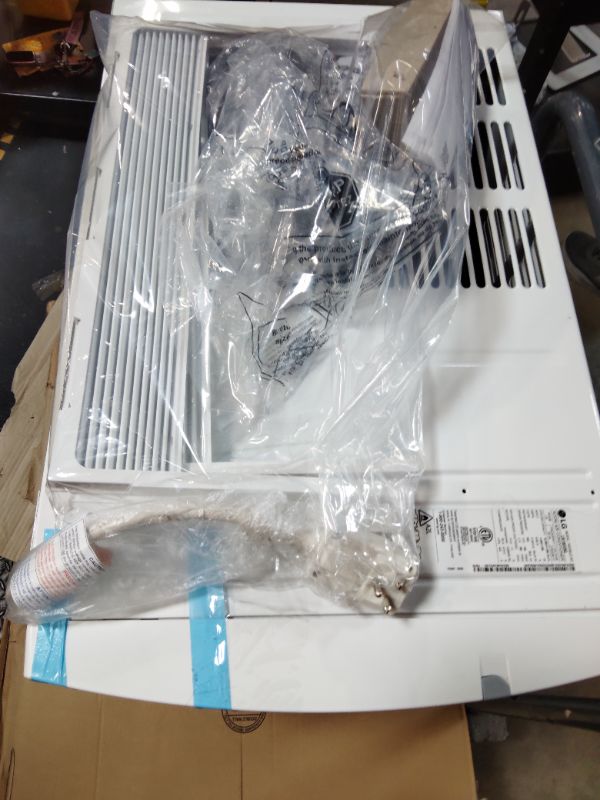 Photo 1 of ***FOR PARTS ONLY/ HAS MINOR OUTER DAMAGE/ COMPRESSOR STARTS & STOPS **** LG 18,000 BTU Window Air Conditioner, 230/208V, Cools 1,000 Sq.Ft. (25' x 40' Room Size), Quiet Operation, Electronic Control with Remote, 3 Cooling & Fan Speeds, Auto Restart, Whi