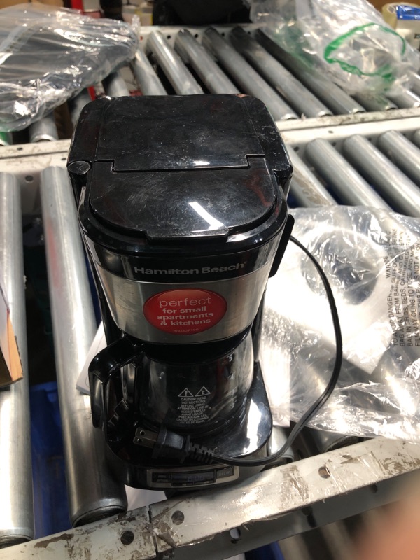 Photo 1 of **HEAVILY USED**
Hamilton Beach 5 Cup Drip Coffee Maker with Easy FrontFill Basket, Compact Design, Programmable Clock, Glass Carafe, Auto Pause and Pour, Black & Stainless Steel (46111)