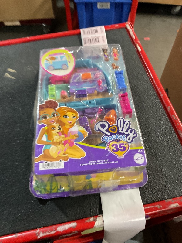 Photo 2 of **BOX DAMAGED, APPEARS TO CONTAIN ALL  PIECES**
Polly Pocket Dolls & Playset, Seaside Puppy Ride Compact with 11 Accessories, Travel Toy with Fidget Exterior