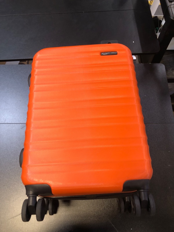 Photo 1 of Amazon Basics Expandable Hardside Carry-On Luggage, Suitcase with Wheels, 21-Inch Spinner with Four Spinner Wheels and Scratch-Resistant Surface, Orange