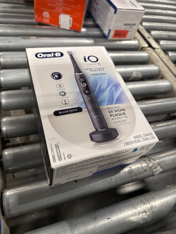 Photo 1 of Oral-B iO Deep Clean + Protect Rechargeable Electric Toothbrush, Black with a iO Series 7 Toothbrush, 2 Replacement Brush Heads, and a Charging Travel Case