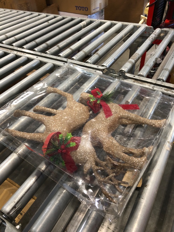 Photo 1 of ***USED***GEDLIRE Christmas Reindeer Figurine Decorations 2 Pcs, 12.6” Holiday Standing Deer Statues with Red Bow, Glitter Gold Christmas Elk Ornaments for Dinner Tabletop Centerpiece Home Decor, Champange Gold