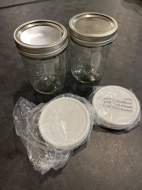 Photo 1 of Wide Mouth Mason Jars 16 oz - (2 Pack) - Wide Mouth 16-Ounces Pint Mason Jars with White M.E.M Food Storage Plastic Lids - For Storage, Canning, Freezing, Leak Proof, Microwave & Diswasher Safe
