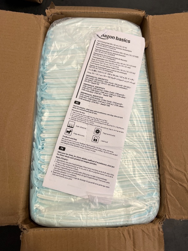 Photo 1 of Amazon Basics Dog and Puppy Pee Pads with Leak-Proof Quick-Dry Design for Potty Training, Standard Absorbency, Regular Size, 22 x 22 Inches, Pack of 100, Blue & White