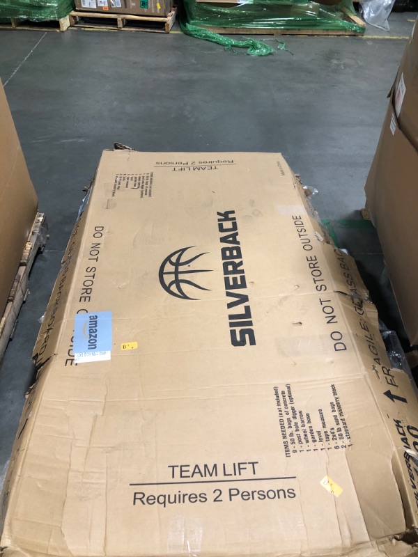 Photo 1 of Silverback 54" In-Ground Height Adjustable Basketball System with Tempered Glass Backboard, Pro-Style Breakaway Rim, and Backboard Pad