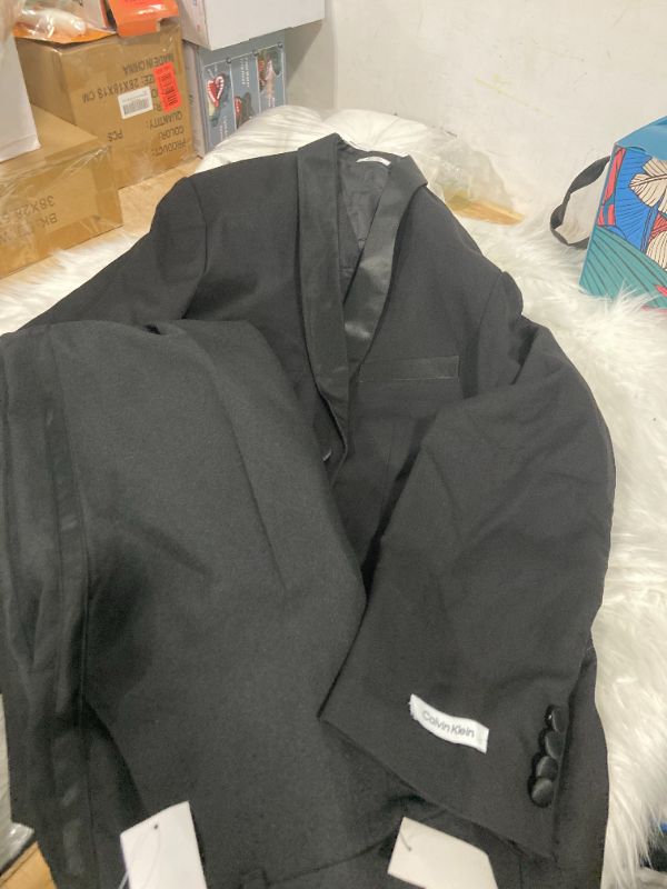 Photo 2 of Calvin Klein Boys 2-Piece Formal Tuxedo Suit Set, Includes Jacket & Dress Pants, Satin Trim Detailing & Functional Pockets, Black  PANTS SIZE 20 JACKET SIZE18 