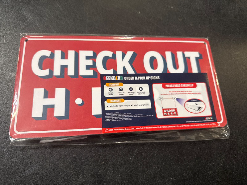 Photo 1 of GEEKBEAR Check Out Here Sign Hanging from Ceiling - 12 x 6 in (Red)


