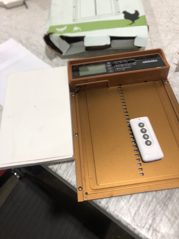 Photo 1 of Okkobi Automatic Chicken Coop Door Solar Powered - LCD Display - Chicken Coop Door with Remote Control, Light Sensor & Timer - Security & Peace of Mind: Anti-Pinch Function - 5-Year Protection