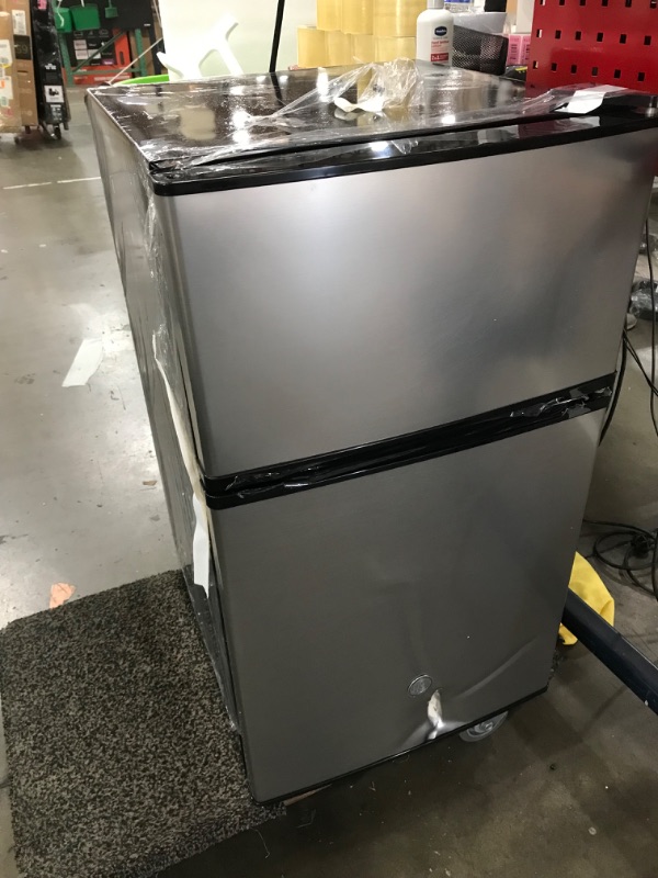 Photo 2 of *DAMAGED* GE Mini Fridge With Freezer | 3.1 Cubic Ft. | Double-Door Design With Glass Shelves, Crisper Drawer & Spacious Freezer | Small Refrigerator Perfect for the Garage, Dorm Room, or Bedroom | Clean Steel