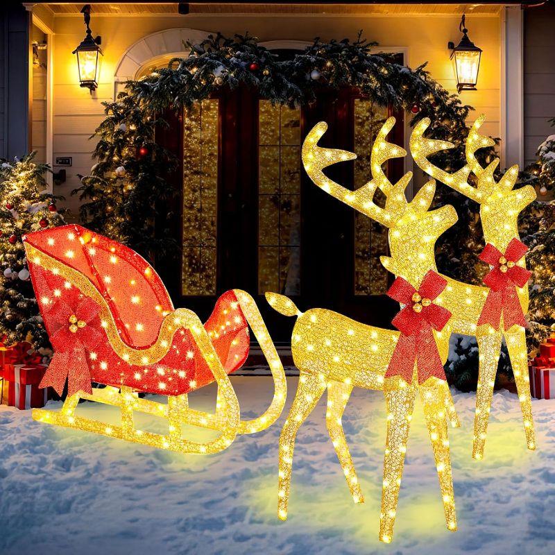 Photo 1 of 3 Piece Lighted Christmas Reindeer and Sleigh 4 ft Reindeer and Sleigh Outdoor Decorations Yard Decorations with LED Lights and Bow Tie for Yard, Garden, Lawn Decoration (Gold,Cloth)