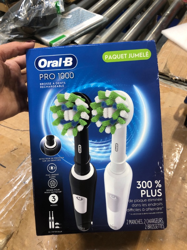 Photo 1 of Oral-B Pro 1000 CrossAction Electric Toothbrush, Black and White, 2 Count Black & White 2 Count (Pack of 1)