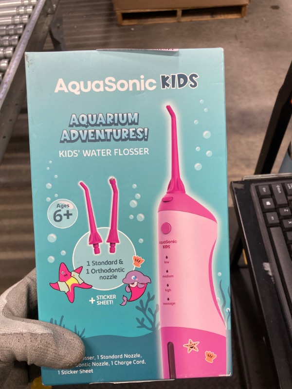 Photo 2 of AquaSonic Kids' Water Flosser for Ages 6+ | Standard Nozzle, Orthodontic Nozzle & Waterproof Stickers | 4 Flossing Modes | Aquarium Adventures Theme (Pink)