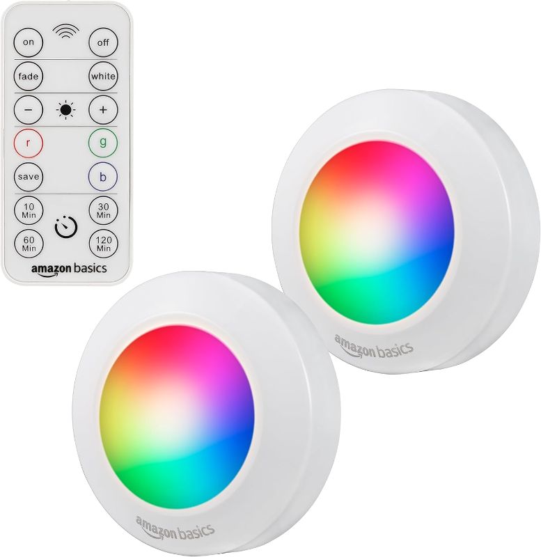 Photo 1 of Amazon Basics LED Puck Lights, Color Changing, Battery Operated, IR Remote, 40 Lumens, 2 Pack, Wireless Lights, Stick on Lights, Under Cabinet Lighting, Ideal for Closets, and More, White
