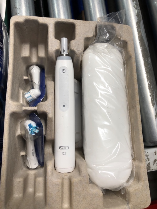 Photo 3 of ***PREV OPENED, APPEARS UNUSED***
Oral-B iO Deep Clean + Protect Rechargeable Electric Toothbrush, White with a iO Series 7 Toothbrush, 2 Replacement Brush Heads, and a Charging Travel Case