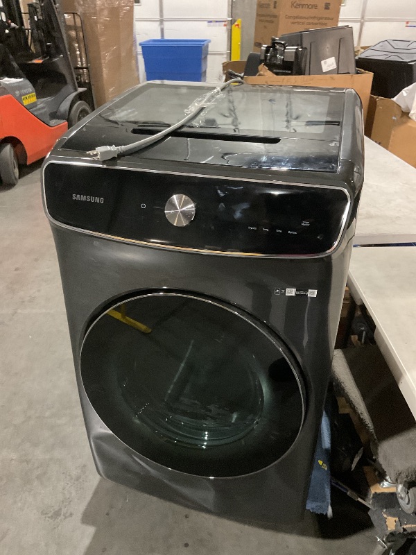 Photo 2 of ***DAMAGED - DENTED - UNTESTED - SEE PICTURES***
SAMSUNG 7.5 Cu. Ft. Smart Dial Gas Dryer with FlexDry, Dry 2 Loads in 1 Large Capacity Machine, Super Speed 30 Minute Clothes Drying Cycle, WiFi Connected Control, DVG60A9900V/A3, Brushed Black