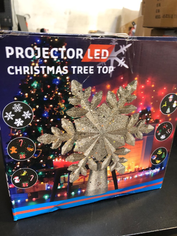 Photo 2 of DG-Direct Christmas Tree Topper Lighted with 6 Projected Patterns, Led Rotating Magic Snowflake, 3D Hollow Glitter Lighted Silver Snow Tree Topper for Christmas Tree Decorations, Gold