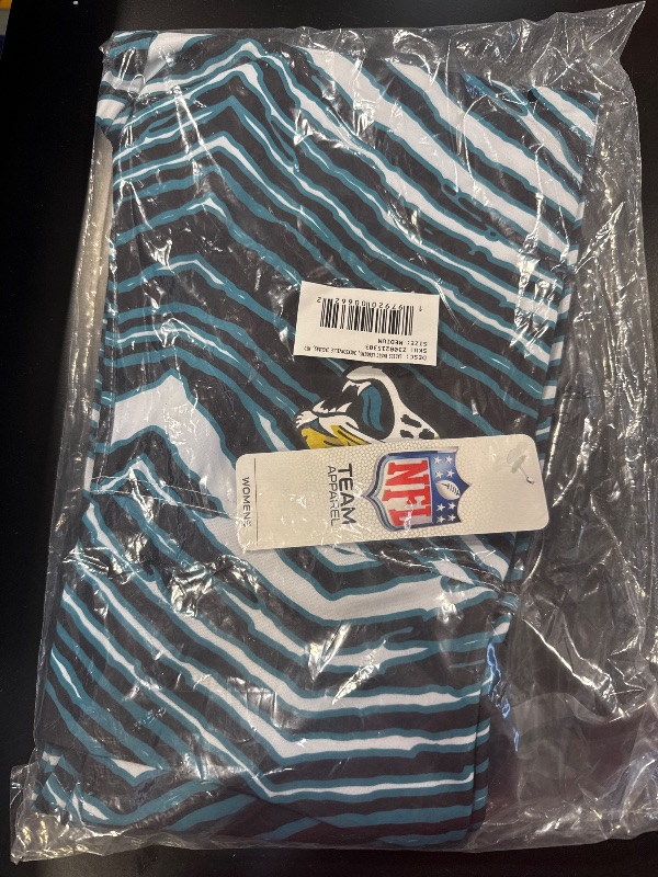 Photo 2 of Zubaz NFL Women's Basic Zebra Print Legging, Jacksonville Jaguars, Medium Team Color