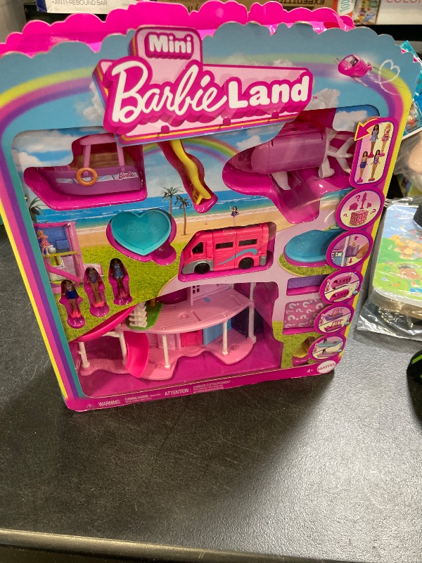 Photo 2 of Barbie Mini BarbieLand DreamHouse & 3-Vehicle Playset with 4 1.5-Inch Dolls, Doll House Furniture & Accessories, Includes DreamCamper, Boat & Plane